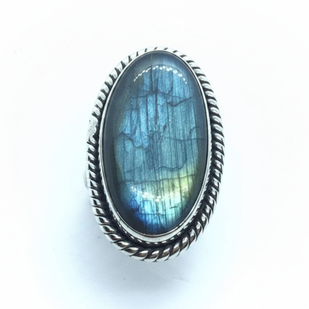 Rare Earth Gallery labradorite ring with elongated oval cabochon in a sterling silver rope-stamped bezel setting.