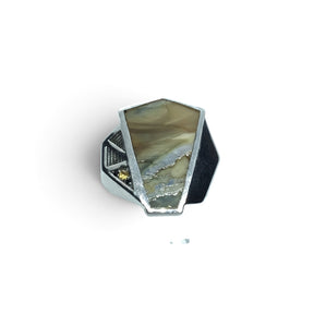 Rare Earth Gallery wooly mammoth tooth fossil ring featuring yellow sapphires set in a geometric silver band.