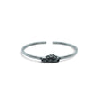 Rare Earth Gallery Campo De Cielo meteorite cuff bracelet featuring a rough freeform stone in a silver bezel setting.