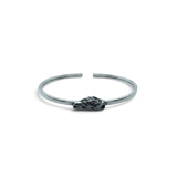 Rare Earth Gallery Campo De Cielo meteorite cuff bracelet featuring a rough freeform stone in a silver bezel setting.