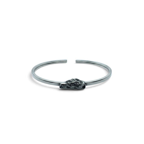 Rare Earth Gallery Campo De Cielo meteorite cuff bracelet featuring a rough freeform stone in a silver bezel setting.
