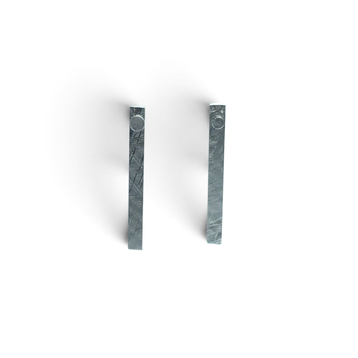 Rare Earth Gallery Muonionalusta meteorite ingot stud earrings with a distinct Widmanstatten pattern in silver grey.