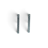 Rare Earth Gallery Muonionalusta meteorite ingot stud earrings with a distinct Widmanstatten pattern in silver grey.