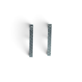 Rare Earth Gallery Muonionalusta meteorite ingot stud earrings with a distinct Widmanstatten pattern in silver grey.