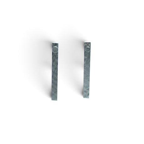Rare Earth Gallery Muonionalusta meteorite ingot stud earrings with a distinct Widmanstatten pattern in silver grey.
