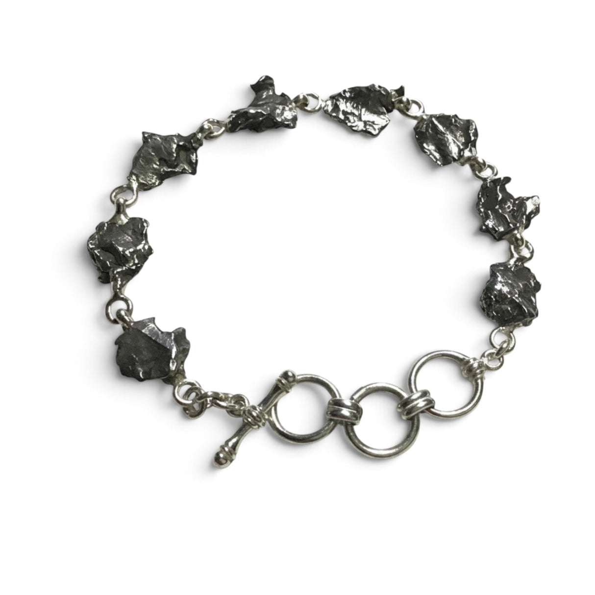 Rare Earth Gallery Campo De Cielo meteorite link bracelet featuring eight raw iron freeform stones and a toggle clasp.