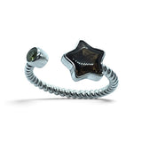 Rare Earth Gallery star-shaped Sericho pallasite meteorite and green moldavite ring on a sterling silver rope band.