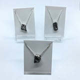 Rare Earth Gallery Campo De Cielo meteorite necklaces in freeform silver bezels on delicate silver box chains.