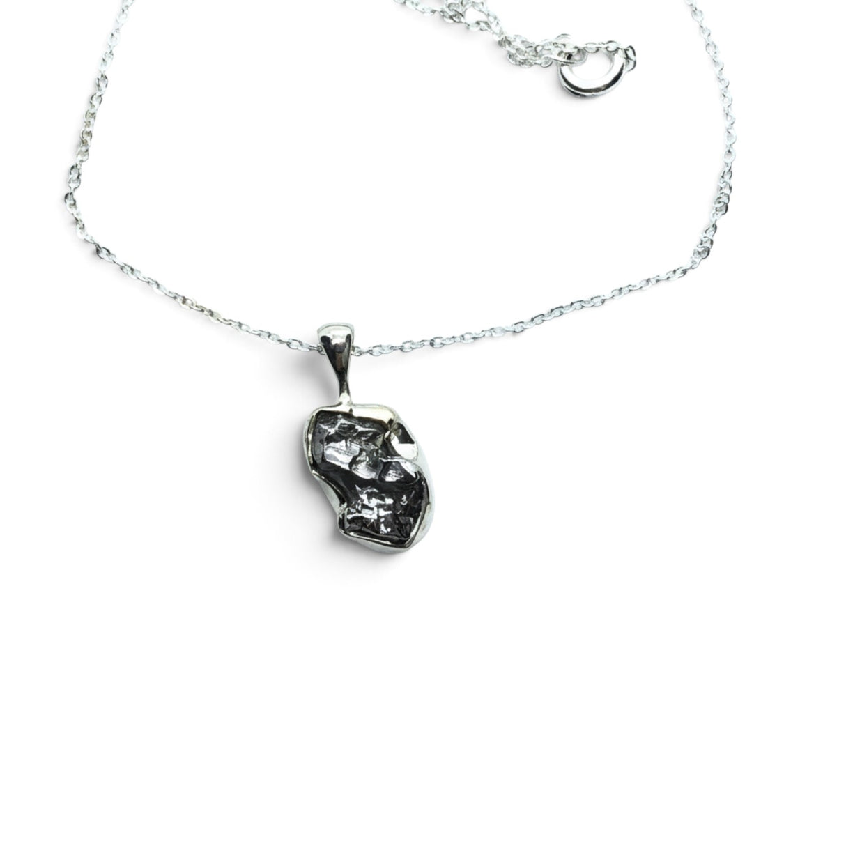 Rare Earth Gallery Campo De Cielo meteorite nugget pendant in a 925 sterling silver bezel on an 18-inch chain.