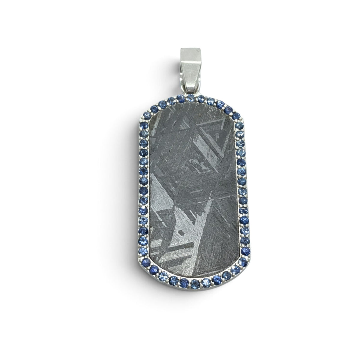 Rare Earth Gallery rounded rectangle Muonionalusta meteorite pendant in a 925 sterling silver bezel with blue sapphires