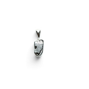 Rare Earth Gallery Campo De Cielo meteorite pendant with an organic nugget shape set in a 925 sterling silver bezel.