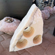 Rare Earth Gallery rustic onyx wine rack with three bottle holes and natural stone texture on a brick surface
