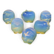 Rare Earth Gallery opalite mini pig carvings with iridescent blue and yellow hues on a black background