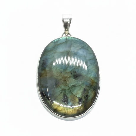 Rare Earth Gallery oval labradorite pendant with teal and yellow flashes and black accents in a silver setting.