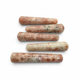 Rare Earth Gallery sunstone massage wands with polished cylindrical shapes and natural orange and cream mineral flecks