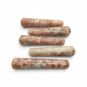 Rare Earth Gallery sunstone massage wands with polished cylindrical shapes and natural orange and cream mineral flecks
