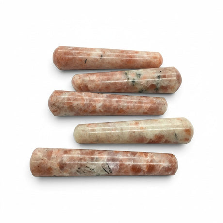 Rare Earth Gallery sunstone massage wands with polished cylindrical shapes and natural orange and cream mineral flecks