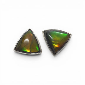 Rare Earth Gallery triangle ammolite stud earrings featuring iridescent green and amber fossilized shell in silver.