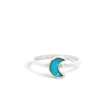 Rare Earth Gallery turquoise half moon ring with a simple silver bezel setting on a white background