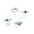 Rare Earth Gallery turquoise nugget rings with round silver bands displayed on clear stands