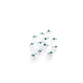 Rare Earth Gallery turquoise nugget dot rings with thin round bands displayed on clear acrylic stands