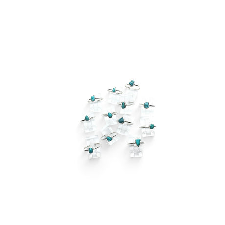 Rare Earth Gallery turquoise nugget dot rings with thin round bands displayed on clear acrylic stands