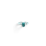 Rare Earth Gallery turquoise nugget ring in a simple silver bezel setting, size 4, isolated on white background.