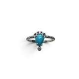 Rare Earth Gallery pear-shaped turquoise cabochon ring with white CZ accents on a stamped 925 sterling silver band