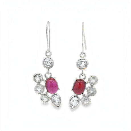 A pair of silver drop earrings featuring oval pinkish-red cabochon gemstones surrounded by clear round and teardrop-cut stones, shown against a plain white background.