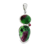 Ruby zoisite pendant angled to show its two green and pink bezel-set stones and prong-set ruby accent