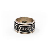 Sterling silver oxidized spinner ring with a row of Star of David symbols on a black band